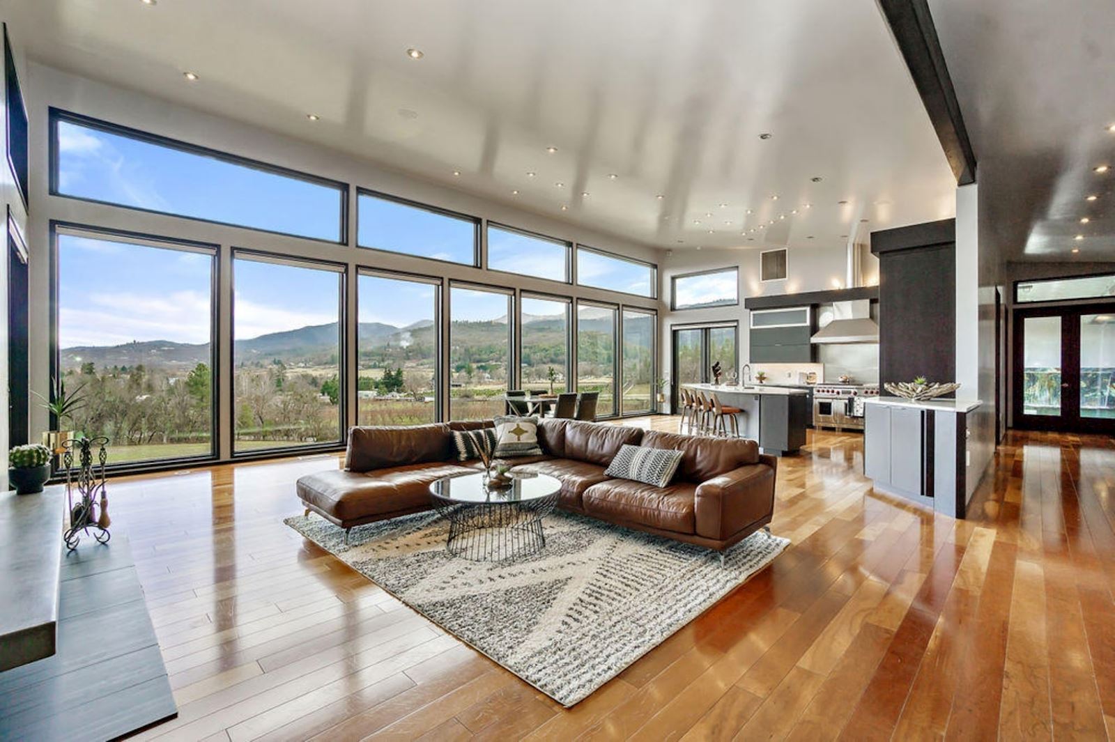 Luxury Home - Living Room with hardwood floors and brown leather sofa