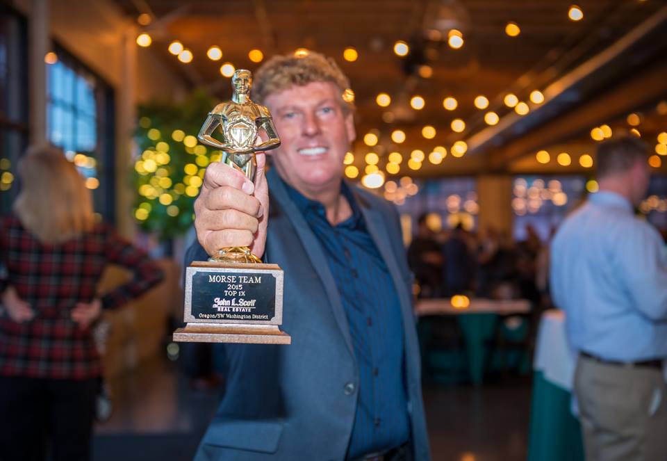 Doug Morse Holding the John L Scott Top 1% Producer award
