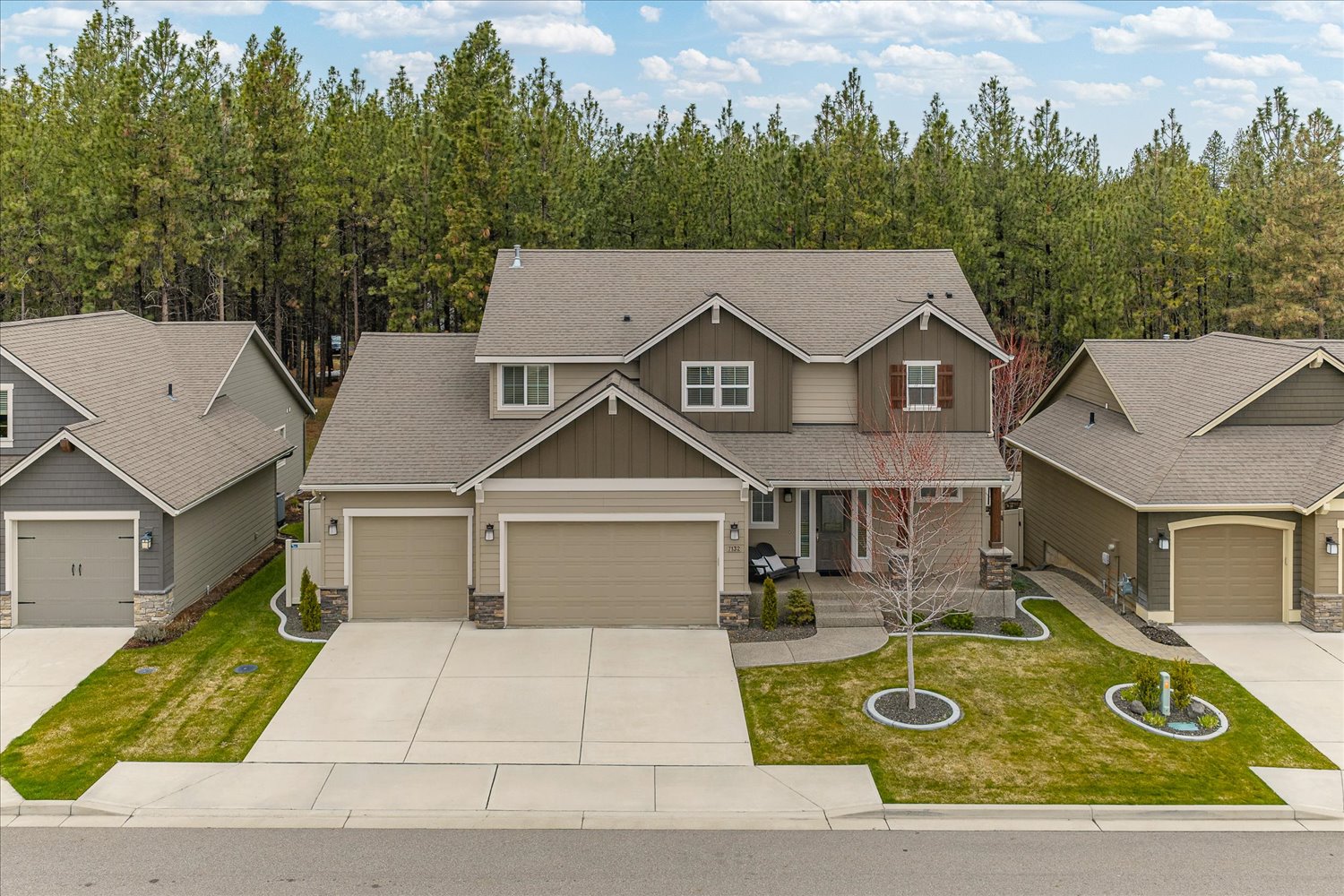 Exterior view of 7132 S Pheasant Ridge Dr in Eagle Ridge Spokane WA featuring a beautifully updated 5-bedroom home with a 4-car garage.
