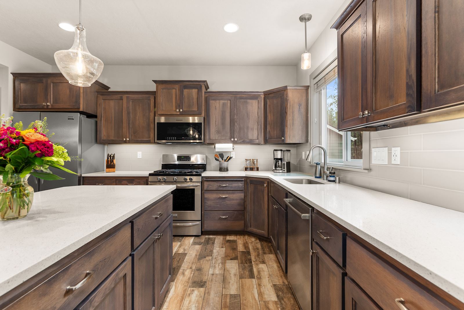 Kitchen at 7132 S Pheasant Ridge Dr in Eagle Ridge Spokane WA with quartz counters, island, and stainless steel appliances.
