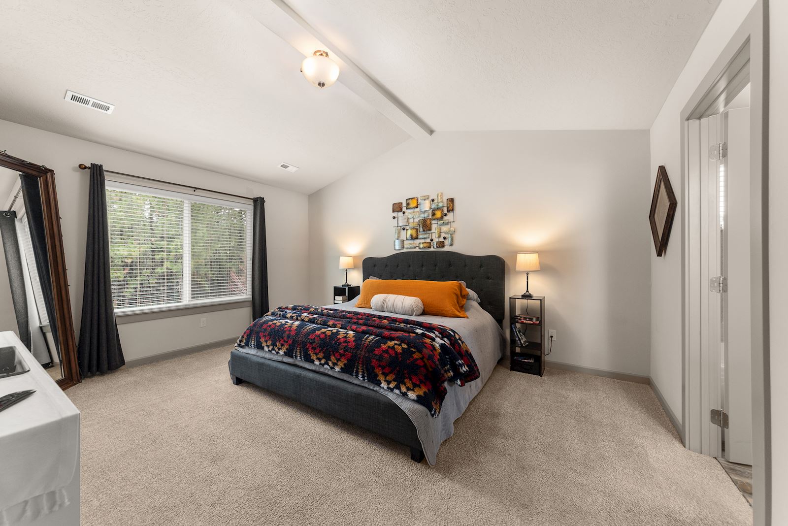 Primary suite at 7132 S Pheasant Ridge Dr in Eagle Ridge Spokane WA with vaulted ceilings and generous bedroom space.