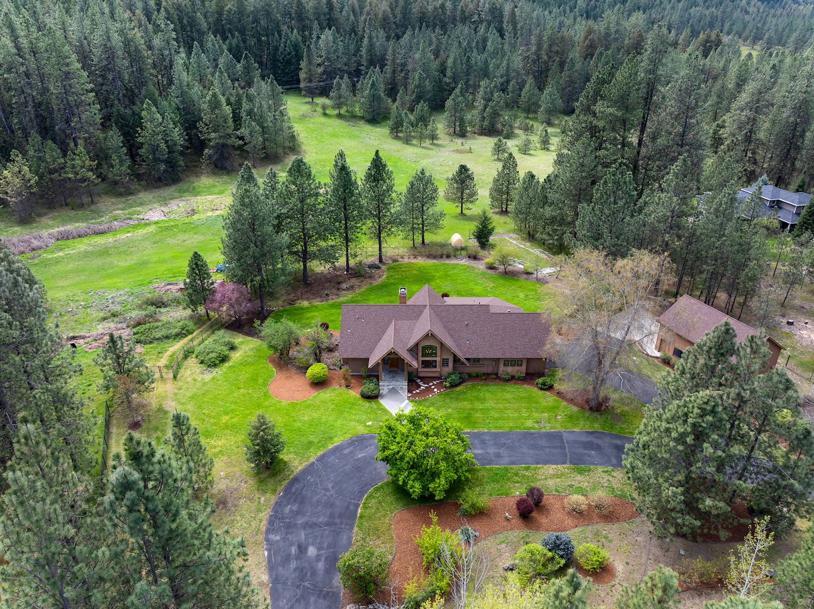 Aerial view of the 12.4-acre luxury estate and custom home at 13609 W Charles Rd in Nine Mile Falls WA 99026