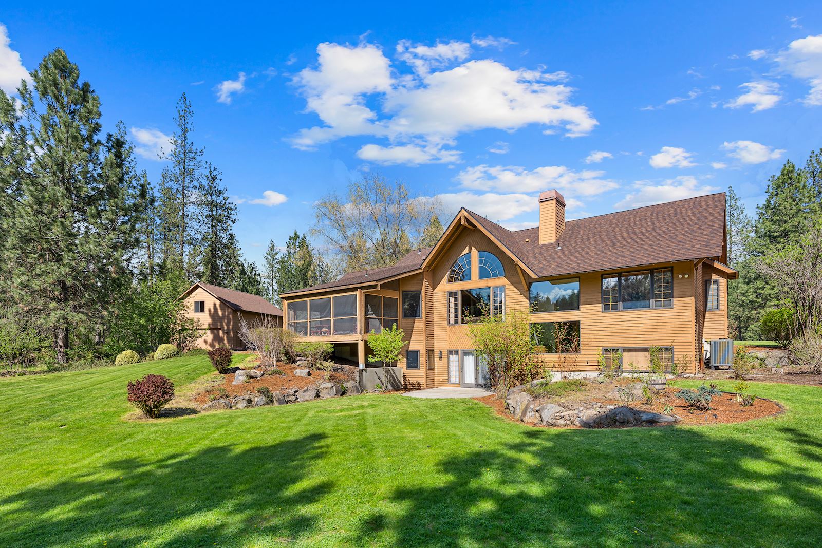 Expansive private backyard of the custom luxury home in Nine Mile Falls WA 99026