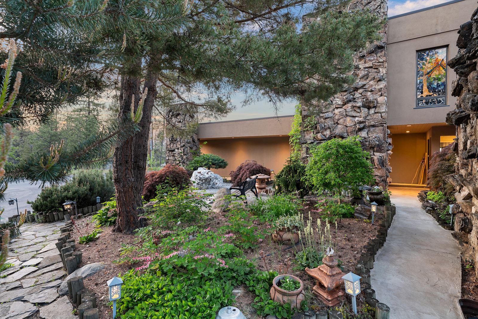 Exterior garden view highlighting custom Steven Drinkard stained glass at the Spokane 99224 luxury home
