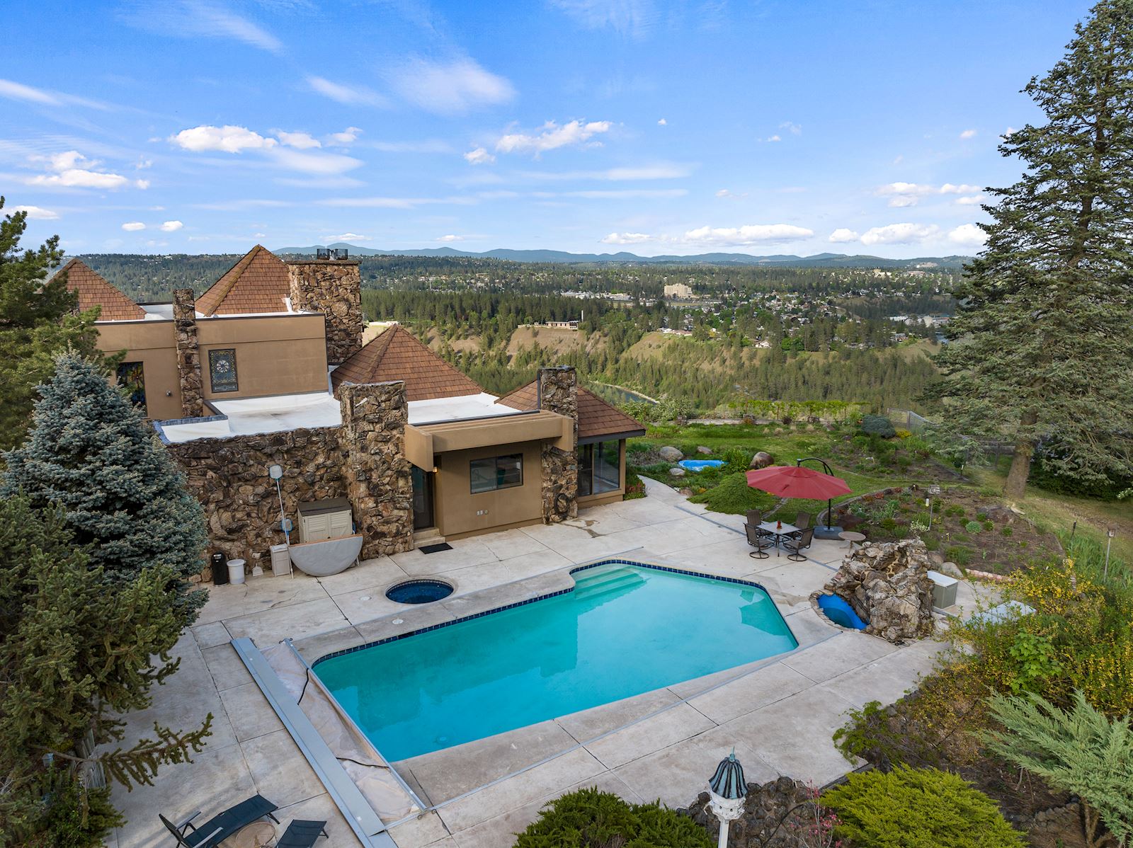 Private Gunite pool looking east over the Spokane River at the Indian Bluff estate