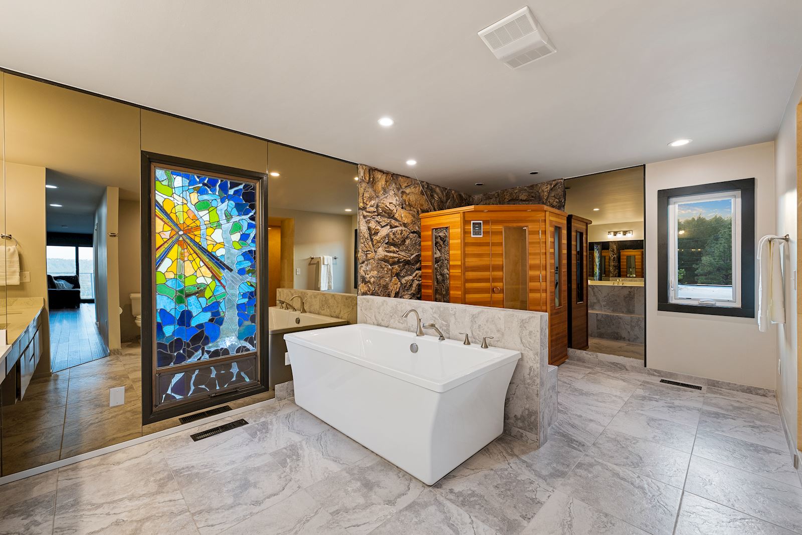 Luxury primary bathroom suite with soaking tub and private sauna at 4302 N Indian Bluff Rd