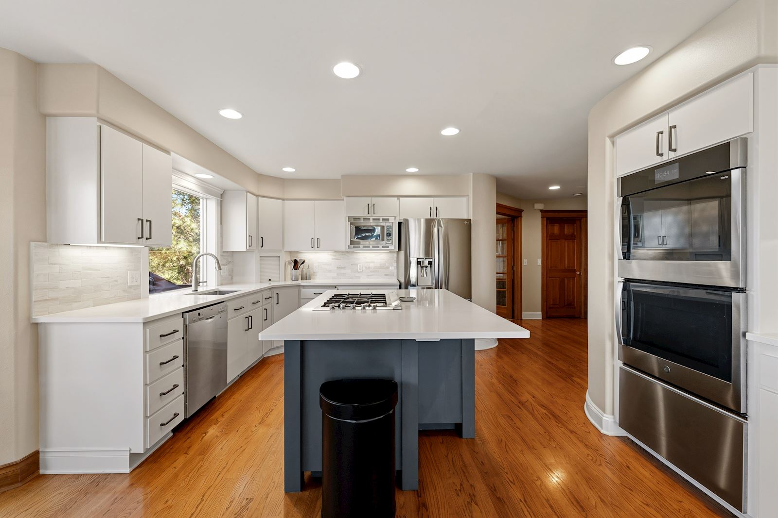 Beautifully remodeled main-floor kitchen with quartz island in the 99223 multi-generational home