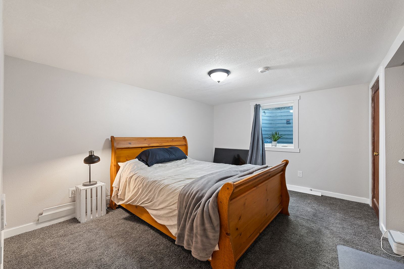 Basement bedroom with egress window at 6516 N Hartley St in North Spokane WA 99208. Real estate listing by Team Dailey | John L. Scott Real Estate.