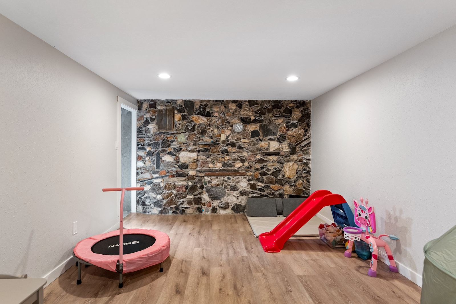 Bright and open basement living room or bonus area at 6516 N Hartley St in North Spokane WA 99208. Real estate listing by Team Dailey | John L. Scott Real Estate.