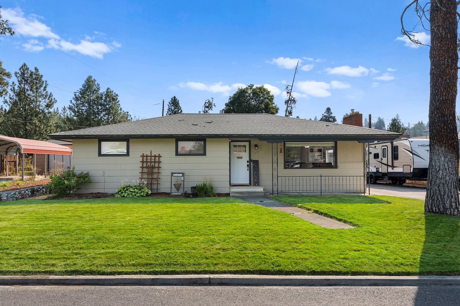 Exterior front entry and yard at 6516 N Hartley St in North Spokane WA 99208. Real estate listing by Team Dailey | John L. Scott Real Estate.
