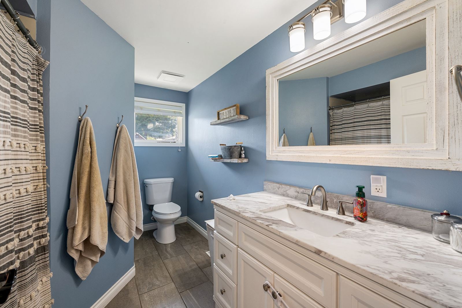 Updated common area bathroom at 6516 N Hartley St in North Spokane WA 99208. Real estate listing by Team Dailey | John L. Scott Real Estate.