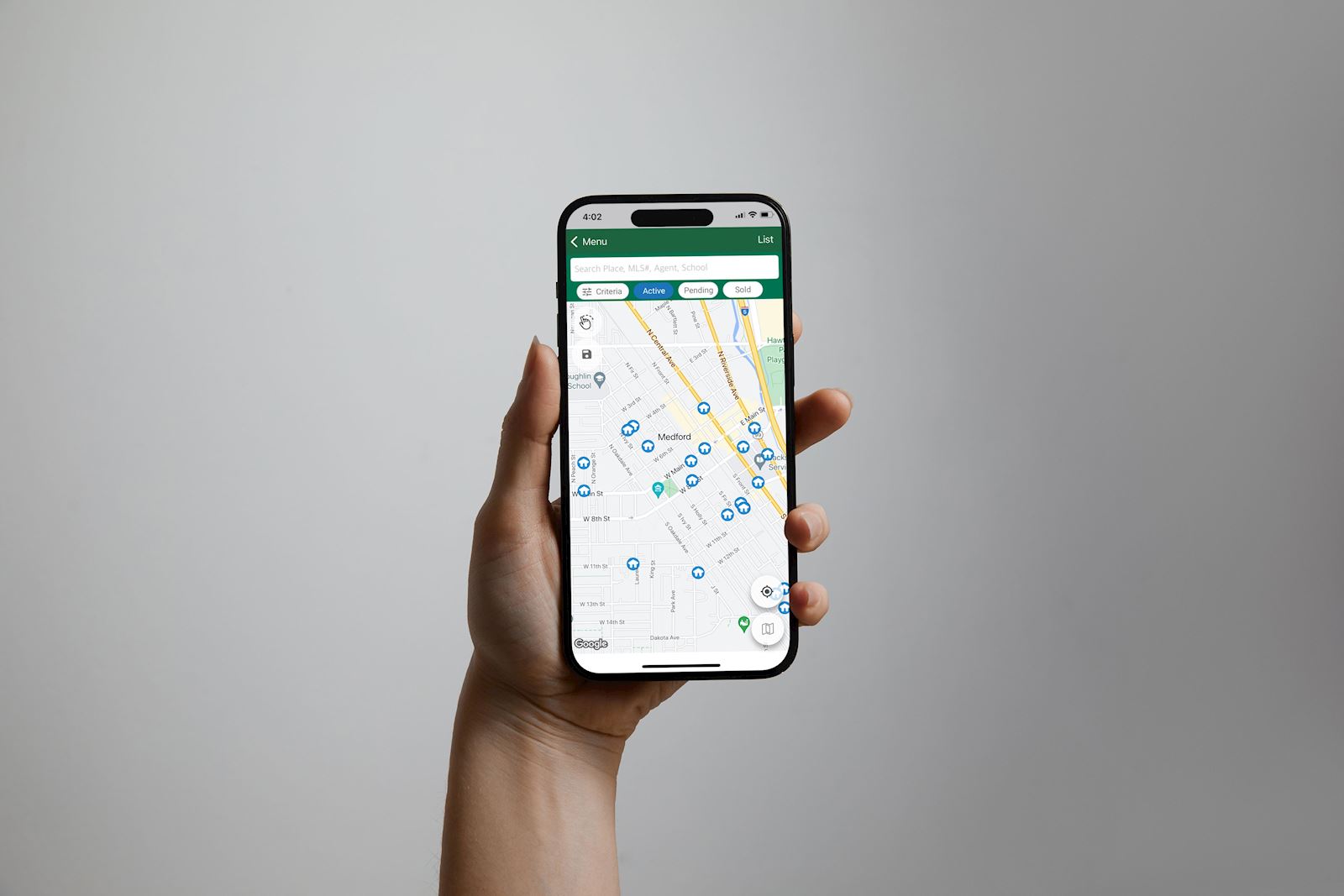 Hand holding a cell phone; JLS App - Mock-Up