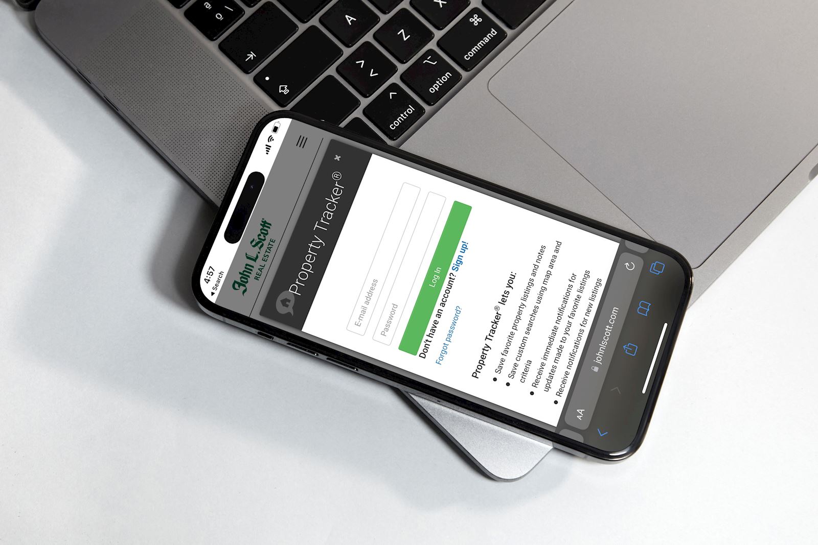 Cell Phone on a Laptop Keyboard; JLS Property Tracker Mock-Up