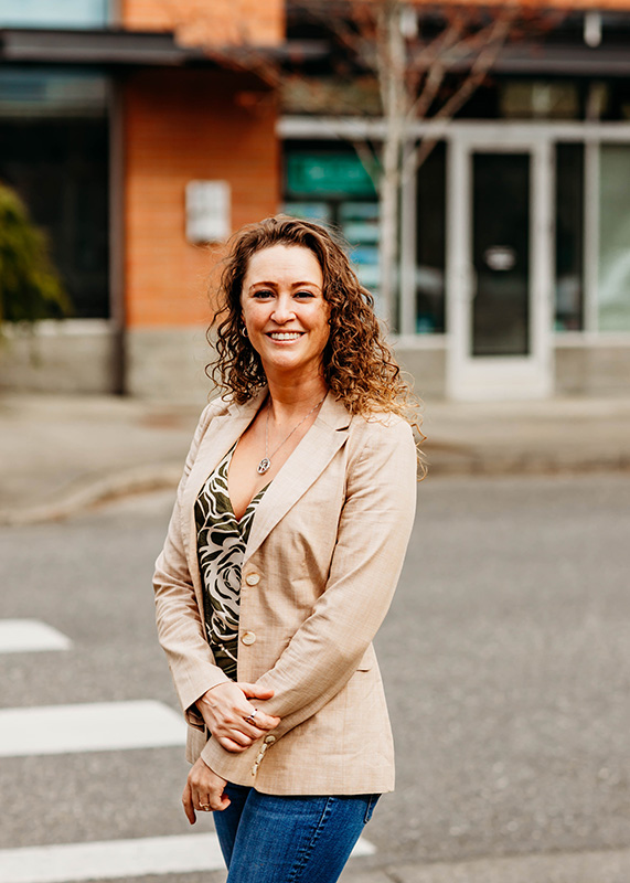 Mira Gregory posing in front of a street