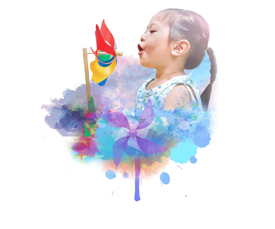 Child blowing a colorful pinwheel