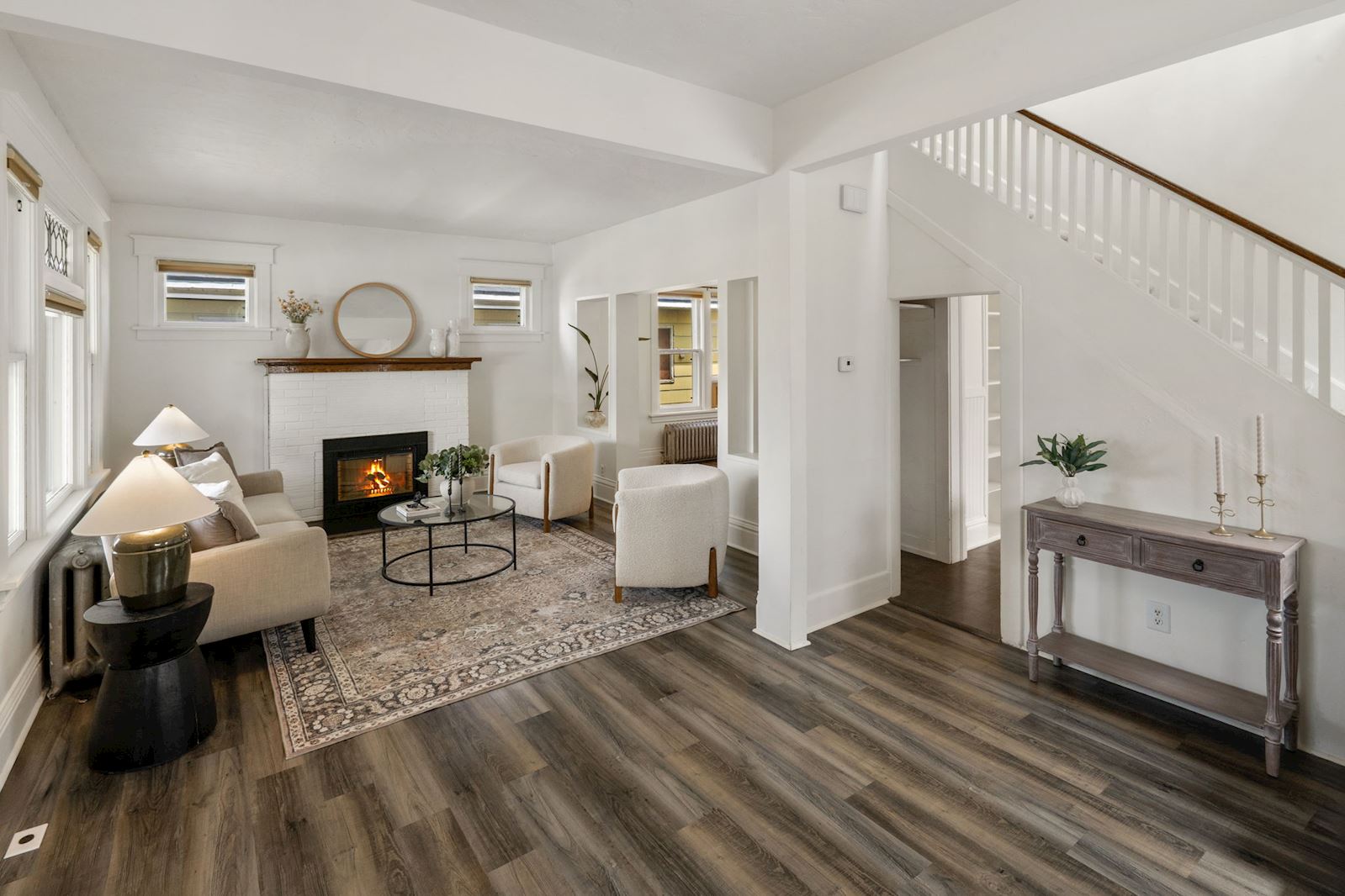 Previous listing: Living room with white brick fireplace, wood mantel, and staircase